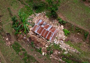 A house on the higher reaches of mountains destroyed in Saturdays earthquake is seen from a helicopter near Dhadingbesti, in Nepal, Wednesday, April 29, 2015.  The first aid shipments reached a hilly district near the epicenter of Nepal's earthquake, a U.N. food agency official said, and distribution of food and medicine would start Wednesday, five days after the quake struck. (AP Photo/Manish Swarup)