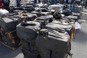This photo provided by the U.S. Coast Guard, a crewman from the Coast Guard Cutter Boutwell shows some of more than 28,000 pounds of cocaine, seized at sea and offloaded at Naval Base San Diego Thursday, April 16, 2015. The vessel arrived with more than 14 tons of cocaine, part of what authorities described as a surge of seizures near Central and South America. (U.S. Coast Guard photo by Petty Officer 1st Class Henry G. Dunphy via AP) MANDATORY CREDIT