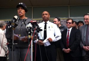 Baltimore Mayor Stephanie Rawlings-Blake, left, speaks as Baltimore Police Commissioner Anthony Batts, center, listens, during a news conference, Tuesday, April 28, 2015, in Baltimore, in the aftermath of rioting following Monday's funeral for Freddie Gray, who died in police custody. (AP Photo/Jessica Gresko)