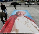 A large poster of late Pope John Paul II is laid out as Roman Catholic faithful prepare to mark the 10th anniversary of his death in Warsaw, Poland, on Thursday, April 2, 2015.(AP Photo/Czarek Sokolowski)
