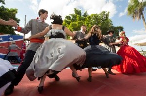 Descendants of American Southerners wearing Confederate-era dresses and uniforms dance during a party to celebrate the 150th anniversary of the end of the American Civil War in Santa Barbara d'Oeste, Brazil, Sunday, April 26, 2015. For many of the residents of Santa Barbara dOeste and neighboring Americana, in Brazils southeastern Sao Paulo state, having Confederate ancestry is a point of pride and is celebrated in high style at the annual Festa dos Confederados, or Confederates Party in Portuguese. (AP Photo/Andre Penner)