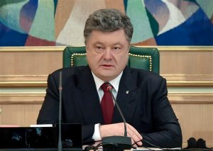 Ukraine's President Petro Poroshenko speaks to official in his office in Kiev, Ukraine, Monday, April 6, 2015.  Poroshenko on Monday April 6, 2015, publicly lifted his objections to a referendum that could give more powers to the restive regions engulfed in more than a year of warfare, reversing his governments previous position. (AP Photo/Mykola Lazarenko, Pool)