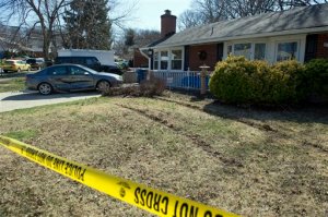 The damaged car of the Preston Hall family sits in their driveway on Cindy Lane in Annandale, Va., Tuesday, March 31, 2015, near Inova Fairfax Hospital. A prisoner who escaped with a gun from the hospital and carjacked a car with a woman inside, crashed the stolen car into Hall's wife's car, at right, after driving across their front yard.  (AP Photo/Cliff Owen)