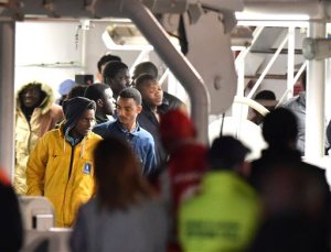 Survivors of the boat that overturned off the coasts of Libya Saturday, wait to disembark from Italian Coast Guard ship Bruno Gregoretti, at Catania Harbor, Italy, Monday, April 20, 2015. A smuggler's boat crammed with hundreds of people overturned off Libya's coast as rescuers approached, causing what could be the Mediterranean's deadliest known migrant tragedy and intensifying pressure on the European Union Sunday to finally meet demands for decisive action. (AP Photo/Carmelo Imbesi )