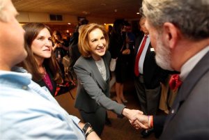 Former Hewlett-Packard CEO Carly Fiorina, shakes hands as she arrives for a business luncheon at the Barley House with New Hampshire Republican lawmakers, Tuesday, April 28, 2015, in Concord, N.H. (AP Photo/Jim Cole)