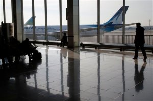 A traveller waits at Paris Orly airport, Wednesday April 8, 2015. French air traffic controllers called a two-day strike in a quarrel over working and retirement conditions, prompting the cancellation of 40 percent of flights across France. (AP Photo/Francois Mori)