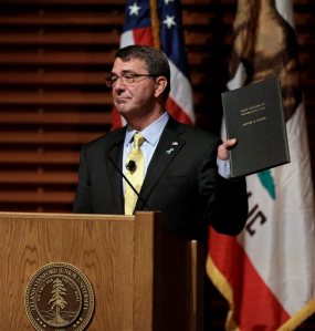 Defense Secretary Ash Carter holds a book during a speech Thursday, April 23, 2015, in Stanford, Calif. Carter's speech is entitled Rewiring the Pentagon: Charting a New Path on Innovation and Cybersecurity. (AP Photo/Ben Margot)