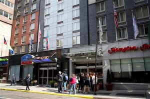 This March 31, 2015 photo shows three hotels that share the same building, from left, Holiday Inn Express and Candlewood Suites, both Intercontinental Hotels Group brands, and Hampton Inn, a Hilton brand, on West 39th Street in New York. The world’s 10 largest hotel chains offer a combined 113 brands _ 31 of which didn’t exist a decade ago. And there’s no sign of this proliferation slowing down. (AP Photo/Mark Lennihan)