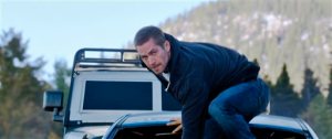FILE - This undated file photo provided by Universal Pictures shows, Paul Walker as Brian, in a scene from "Furious 7."  Furious 7 topped Age of Adaline and lead the box office for a fourth straight week. The Universal action film made an estimated $18.3 million in North American theaters over the weekend, according to studio estimates Sunday, April 26, 2015. (AP Photo/Universal Pictures, File)