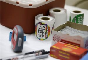 Stickers are given to clients after they get tested for HIV at the One-Stop Shop at the Austin Community Outreach Center,  Tuesday, April 21, 2015, in Austin, Ind.  Indiana health officials trying to contain an HIV outbreak tied to needle-sharing among drug users are getting helping from specialists from other states in tracking down about 130 additional people who also may be infected. (AP Photo/Darron Cummings)