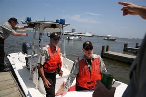 Flotilla volunteers take lunch donated by the Salvation Army of Coastal Alabama out to first responders as search and rescue operations continue  off Dauphin Island, Ala. on Sunday, April 26, 2015. Coast Guard crews continued searching Sunday for five people missing in the water after recovering two bodies following a powerful storm that capsized several sailboats participating in a regatta near Mobile Bay, Ala. (Sharon Steinmann/AL.com via AP)  MAGS OUT; MANDATORY CREDIT