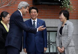 Secretary of State John Kerry, second from left, greets Japanese Prime Minister Shinzo Abe, center, and his wife Akie Abe, right, in front of Kerry's residence in the Beacon Hill neighborhood of Boston, Sunday, April 26, 2015. Abe arrived in the U.S. Sunday for a weeklong visit. (AP Photo/Steven Senne)
