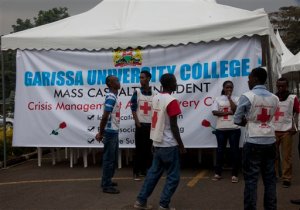 Red Cross staff wait to help relatives in Thursday's attack on a university, at Chiromo funeral home, Nairobi, Kenya, Monday, April 6, 2015. Al-Shabab gunmen killed scores of people at a university in northeastern Kenya in sectarian violence on Thursday. (AP Photo/Sayyid Azim)