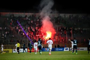 FILE - In this Sunday, Feb. 8, 2015 file photo, Ultras White Knights soccer fans light flares during a match between Egyptian Premier League clubs Zamalek and ENPPI at the Air Defense Stadium in a suburb east of Cairo, Egypt. At least 22 soccer fans were crushed to death outside an air defense stadium in Cairo after police fired tear gas to break up the crowd waiting in a fenced, narrow corridor to watch. Police accused the fans of attacking the force, and rioting to enter the stadium. On Tuesday, March, 17, 2015 the chief prosecutor general also referred 16 fans to trial, accusing them of belonging to the Muslim Brotherhood. (AP Photo/Ahmed Abd El-Gwad, El Shorouk Newspaper, File) EGYPT OUT