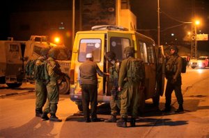 Israeli soldiers search a van in the village of Beit Anun, West Bank, Thursday, April 2, 2015. An Israeli has gone missing in the West Bank and troops are searching for the man amid fears he could have been abducted. Last year, Palestinians abducted and killed three Israeli teenagers sparking a chain of events that led to a 50 day war in Gaza. (AP Photo/Mahmoud Illean)