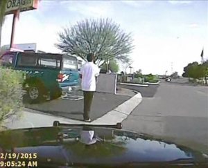 In this Feb. 19, 2015, frame from a dash cam video provided by the Marana Police Department, a police vehicle nears Mario Valencia in Marana, Ariz. Dramatic dash cam video released Tuesday, April 14 shows a police officer using his cruiser to ram the armed suspect, Valencia, sending him flying in the air before the car smashes into a wall. Valencia survived the crash, and prosecutors cleared the officer of any wrongdoing. (Marana Police Department via AP)