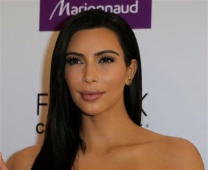 FILE - In a Wednesday, April 15 2015 file photo, Kim Kardashian attends a photocall to launch hair products in Paris. Kardashian said during an appearance on NBCs Today show on Monday, April 27, 2015, that she and her family support her stepfather Bruce Jenner 100 percent as he goes through gender transition, even though family members are still adjusting to that news in what she called a daily process.(AP Photo/Jacques Brinon, File)