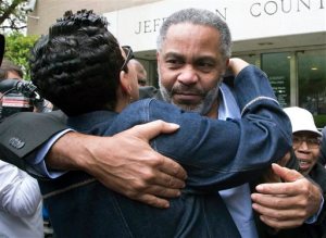 Pat Turner, left, hugs Anthony Ray Hinton as he leaves the Jefferson County jail, Friday, April 3, 2015, in Birmingham, Ala. Hinton spent nearly 30 years on Alabama's death row, and was set free Friday after prosecutors told a judge they won't re-try him for the 1985 slayings of two fast-food managers. (AP Photo/Hal Yeager)