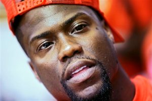 File-This June 3, 2014, file photo shows actor/comedian Kevin Hart, right, making a selfie of himself with fans as he serves sandwiches at A&R Barbeque in Memphis, Tenn. Hart, Anthony Anderson and other celebrities through their foundations teamed up with the United Negro College Fund to donate scholarships to worthy students who are farthing their education. More than $500,000 in scholarships was collectively given to 20 students by Anderson, singers Usher and Toni Braxton, producer Pharrell Williams, rapper Big Sean and NBA player Chris Paul. The scholarships on the show were funded by the celebs except for two that were match by the UNCF. (AP Photo/The Commercial Appeal, Yalonda M. James)
