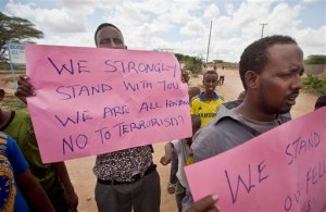 Kenyan Muslims demonstrate against Thursday's attack and in solidarity with non-Muslims who were targeted, on a street in Garissa, Kenya Friday, April 3, 2015. Al-Shabab gunmen rampaged through a university in northeastern Kenya at dawn Thursday, killing scores of people in the group's deadliest attack in the East African country. Four militants were slain by security forces to end the siege just after dusk. (AP Photo/Ben Curtis)