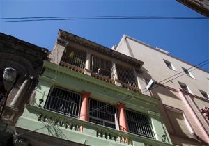 Home owner Israel Rivero looks from his home with rooms for rent in Havana, Cuba, Wednesday, April 1, 2015. The wildly popular online home-sharing service Airbnb will allow American travelers to book lodging in Cuba starting Thursday in the most significant U.S. business expansion on the island since the declaration of detente between the two countries late last year. (AP Photo/Desmond Boylan)
