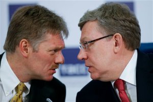 Russian President Vladimir Putin's press secretary Dmitry Peskov, left, speaks to Russia's former finance minister Alexei Kudrin at a round table to mark President Vladimir Putins 15 years in office, some of the presidents long-term allies questioned his political course and warned of economic fallout in Moscow, Russia, Tuesday, March 31, 2015. Alexei Kudrin, Russia's finance minister in 2000-2011 and a former deputy prime minister, said Tuesday that Putin's focus on foreign policy means that Russia won't return in the coming years to the economic growth that would suit a great power.  (AP Photo/Alexander Zemlianichenko)