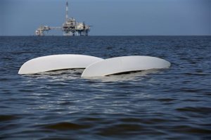 A capsized catamaran drifts in the water as search and rescue operations continue off Dauphin Island, Ala. on Sunday, April 26, 2015. Coast Guard crews continued searching Sunday for five people missing in the water after recovering two bodies following a powerful storm that capsized several sailboats participating in a regatta near Mobile Bay, Ala. (Sharon Steinmann/AL.com via AP) 