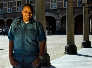 In this April 16, 2015 photo, Jamaican Simone Edwards, who sought asylum abroad, poses for a portrait in the center of The Hague, Netherlands. In 2008, Edwards survived an attack by two gunmen who hissed the anti-gay epithet sodomite at her as she lay bleeding on a street from two bullets. She later received asylum in the Netherlands and her story was told in the 2013 documentary The Abominable Crime. (AP Photo/Peter Dejong)