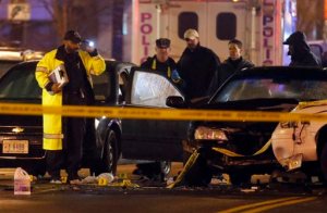 Law enforcement officers investigate the scene involving at least one wrecked DC Metro police car Thursday, April 9, 2015, in Washington. An armed man kidnapped a woman, shot a Census Bureau guard and led police on a car chase through Maryland and Washington, D.C., on Thursday before authorities cornered him in an exchange of gunfire. (AP Photo/Alex Brandon)