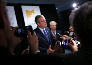 Former Florida Gov. Jeb Bush answers questions from reporters following a speech at the annual meeting of the Ohio Chamber of Commerce, Tuesday, April 14, 2015, in Columbus, Ohio. The GOP White House prospect kicked off a speech in the battleground state with a series of personal recollections, saying he's his "own person." (Jonathan Quilter/The Columbus Dispatch via AP)