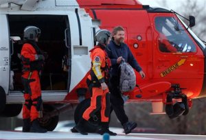 Louis Jordan, right, walks from the Coast Guard helicopter to the Sentara Norfolk General Hospital in Norfolk, Va., after being found off the North Carolina coast, Thursday, April 2, 2015. His family says he sailed out of a marina in Conway, South Carolina, on Jan. 23, and hadn't been heard from since. (AP Photo/The Virginian-Pilot, Steve Earley)