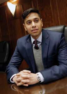 In this April 23, 2015 photo, Shezanne Cassim of Woodbury, Minn., poses in his attorney's office in Minneapolis. Cassim, 30, is seeking a pardon and financial compensation from the United Arab Emirates for spending nine months in a UAE prison for his role in an online parody video about youth culture in Dubai. (AP Photo/Jim Mone)