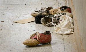 Abandoned shoes lie next to the Elgon A hostel inside the Garissa University College compound that was the scene of last week's attack by al-Shabab gunmen, in Garissa, Kenya Monday, April 6, 2015. Kenya launched air strikes against al-Shabab Islamic militants in Somalia on Sunday afternoon and early Monday morning, following the extremist attack on a Kenyan college that killed 148 people, a military spokesman said. (AP Photo)