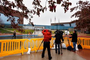 Television journalists film from within a media corral in front of the Arapahoe County Justice Center, on the first day of the trial of Aurora movie theater shootings defendant James Holmes, in Centennial, Colo., Monday April 27, 2015. As the trial begins, the key won't be whether he caused the carnage, but whether Holmes was sane at the time of the killings. (AP Photo/Brennan Linsley)