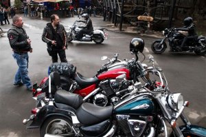 Russian Night Wolves biker club members arrive for a concert in Moscow, Russia, Thursday, April 23, 2015. The Night Wolves, a nationalistic group loyal to Russian President Vladimir Putin, are leaving Moscow on Saturday to ride through  Belarus and Poland on a journey to Berlin to mark the 70th anniversary of the Soviet victory over Nazi Germany. Bikers of the Night Wolves plan to retrace the westward path that Red Army soldiers took across eastern Europe as they fought Nazi troops. (AP Photo/Pavel Golovkin)
