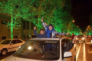 Iranians flash the victory sign from their car while celebrating at a street in northern Tehran, Iran, Thursday, April 2, 2015, after Iran's nuclear agreement with world powers in Lausanne, Switzerland. The United States, Iran and five other world powers on Thursday announced an understanding outlining limits on Iran's nuclear program so it cannot lead to atomic weapons, directing negotiators toward achieving a comprehensive agreement within three months.(AP Photo/Vahid Salemi)