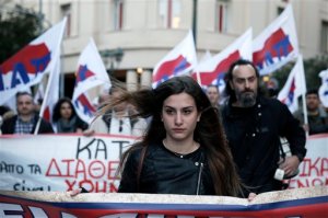 Members of the PAME Communist-affiliated union demonstrate against a decree by Greece's radical left-led government that forces state entities, including hospitals, municipalities and universities, to lend their reserves to the cash-strapped state, in central Athens on Friday, April 24, 2015. Parliament was debating a law retroactively approving the decree later Friday. (AP Photo/Petros Giannakouris)