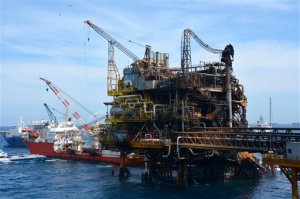 In this Thursday April 2, 2015, handout  photo provided by Petroleos Mexicanos (Pemex), emergency boats works to put out a fire at the Abkatun-A Permanente shallow-water oil platform in the Campeche Sound. Three workers are missing following the huge blaze on the platform in the Gulf of Mexico that killed four workers and burned for hours, Mexico's state oil company said Thursday. (AP Photo/Pemex) 