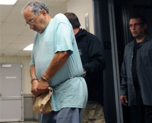 FILE--This Sept. 29, 2014 file photo, Rev. Joseph Maurizo, left, a former priest at Our Lady Queen of Angels Catholic Church in Central City, Pa., is led by US Marshals into US federal court in Johnstown,Pa., for a detention hearing on charges of engaging in illicit sex in foreign countries and possession of child pornography. A new federal indictment returned Tuesday, April 7, 2015, adds two victims and charges that Maurizio sent $8,000 to a charity to help facilitate the trips which ended in 2009. None of the alleged victims are named, but all are under 18. (AP Photo/The Tribune-Democrat, John Rucosky, FILE) MANDATORY CREDIT