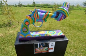 In this Thursday April 2, 2015 photo, a knotted gun sculpture painted by British musician and ex-Beatle Sir Paul McCartney is displayed at a park in the city of Monterrey, Mexico. Thirteen knotted gun sculptures painted by various artists are on display in this city that for years has been plagued with violence generated by warring drug cartels. The original knotted gun sculpture was designed and created by Carl Fredrik Reutersward as a memorial to John Lennon after he was shot and killed in 1980 and is now displayed outside of the United Nations headquarters in New York City.