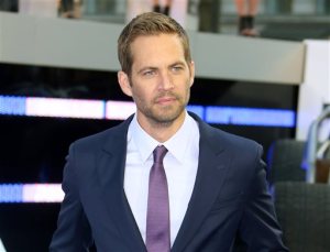 FILE - In this May 7, 2013 file photo, actor Paul Walker arrives for the World Premiere of "Fast & Furious 6," in central London. Wiz Khalifa and Charlie Puth’s song, “See You Again,” a tribute to Walker, hit No.1 on Billboard Hot 100’s chart this week. It is featured on the “Furious 7” soundtrack, which debuted at No.1 on Billboard’s 200 albums chart this week. (Photo by Joel Ryan/Invision/AP)