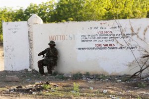A Kenya Defence Forces soldier secures the area around the Garissa University college, in Garissa, Kenya, Thursday, April 2, 2015. Al-Shabab gunmen attacked Garissa University College in northeast Kenya early Thursday, targeting Christians and killing over 100 people and wounding others, according to Kenya's national disaster operations center and the interior minister. (AP Photo/Khalil Senosi)