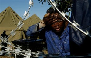 A man washes his face outside a shelter for displaced foreigners in east of Johannesburg, South Africa, Tuesday, April 21, 2015. The South African army has been deployed to areas in that remain volatile after a spate of attacks targeting immigrants, the defense minister announced on Tuesday. (AP Photo/Themba Hadebe)