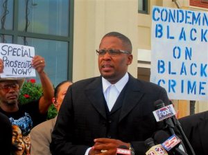 Malik Shabazz, the president and founder of Black Lawyers for Justice, speaks at a rally in front of North Charleston, S.C., City Hall on Monday, April 13, 2015. Shabazz said his group will do its own investigation into the fatal shooting of a black man by a white North Charleston police officer in a case that has renewed the national debate over blacks being killed by white officers. Shabazz has also called for a special prosecutor to investigate. (AP Photo/Bruce Smith)