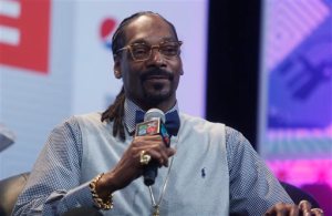 In this March 20, 2015, file photo, Snoop Dogg takes part in the "Keynote Conversation with Snoop Dogg" at the South by Southwest festival in Austin, Texas. State trooper Billy Spears has been reprimanded for posing for a photo with Dogg at the festival because the rapper has several convictions for drug possession. (Photo by Jack Plunkett/Invision/AP, File)