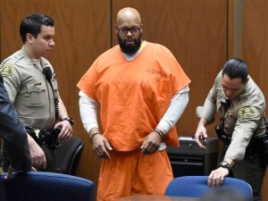 FILE - In this March 9, 2015 file photo, Marion "Suge" Knight, center, arrives in court for a hearing about evidence in his murder case, in Los Angeles. Knight will stand trial on murder and attempted-murder charges after the former rap music mogul struck two men with his pickup truck in January, killing one and seriously injuring the other. Superior Court Judge Ronald Coen made the ruling Thursday after concluding a hearing that focused heavily on testimony from Cle "Bone" Sloan, who was hit outside a Compton burger stand. The judge also reduced bail from $25 million to $10 million. (Kevork Djansezian/Pool Photo via AP, File)
