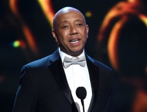 FILE - In this Feb. 6, 2015 file photo, Russell Simmons presents the Vanguard Award on stage at the 46th NAACP Image Awards in Pasadena, Calif. Simmons is producing a brand new stage musical that will celebrate three generations of hip-hop, from Run DMC to Kanye West. Simmons said Thursday, March 19, 2015, that “The Scenario” will feature an original story written by author and hip-hop historian Dan Charnas and aims to premiere in New York City in late 2016. (Photo by Chris Pizzello/Invision/AP, File) 