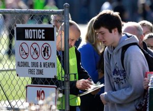 School and other officials check names and release students to parents at a gate at North Thurston High School Monday, April 27, 2015, after a shooting at the school earlier in the morning. Police say no one was injured, and school district officials say the gunman has been apprehended by staff. (AP Photo/Ted S. Warren)