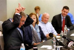 Former Florida Gov. Jeb Bush makes horns as he speaks about getting tough during a meeting with seacoast area business leaders, Wednesday, May 20, 2015, in Portsmouth, N.H. Bush is visiting the nation's earliest presidential primary state as he considers a run for the Republican nomination for president.  AP Photo/Jim Cole)