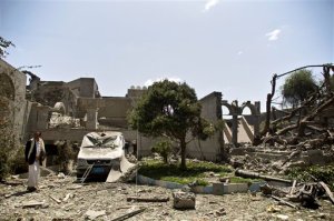 A man loyal to former Yemeni president Ali Abdullah Saleh inspects at Saleh's house destroyed by a Saudi-led airstrike in Sanaa, Yemen, Sunday, May 10, 2015. Yemen's Shiite rebels and their allies in the country's splintered armed forces said Sunday they would accept a five-day humanitarian cease-fire to allow aid to reach civilians after more than a month of daily Saudi-led airstrikes. Saleh and his forces back Shiite rebels also known as the Houthis, who are also backed by Iran. (AP Photo/Hani Mohammed)